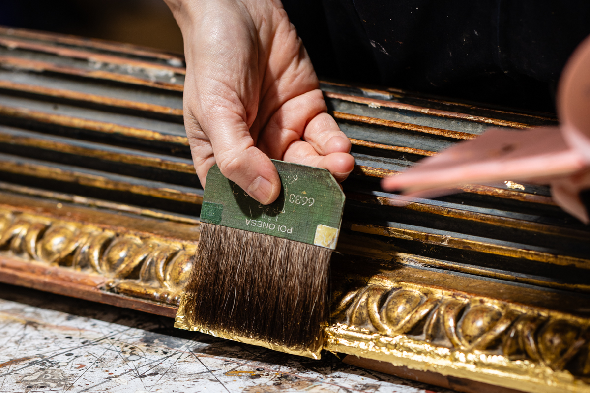 Applying Gold Leaf During Antique Frame Restoration