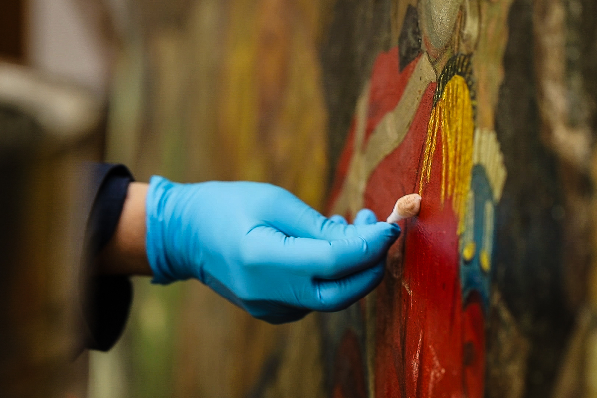 Lowy Conservator Cleaning a Painting