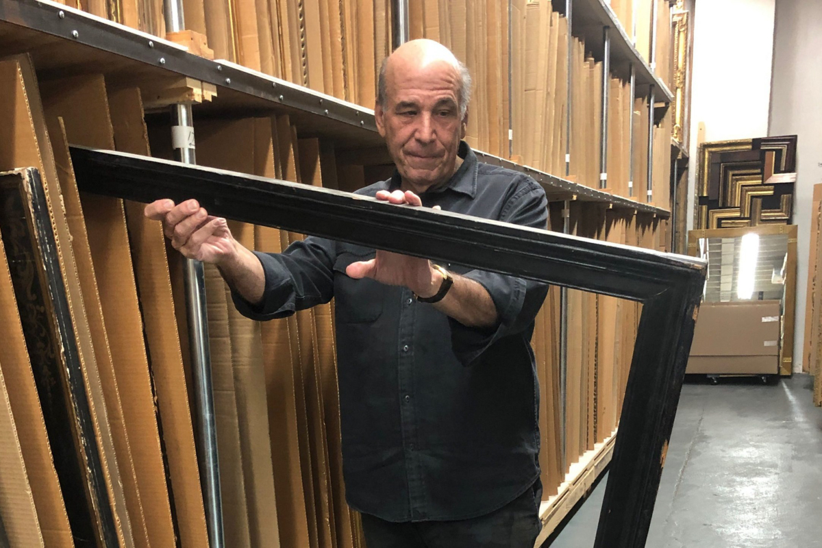 Larry Shar examines one of the antique frames in the Lowy collection