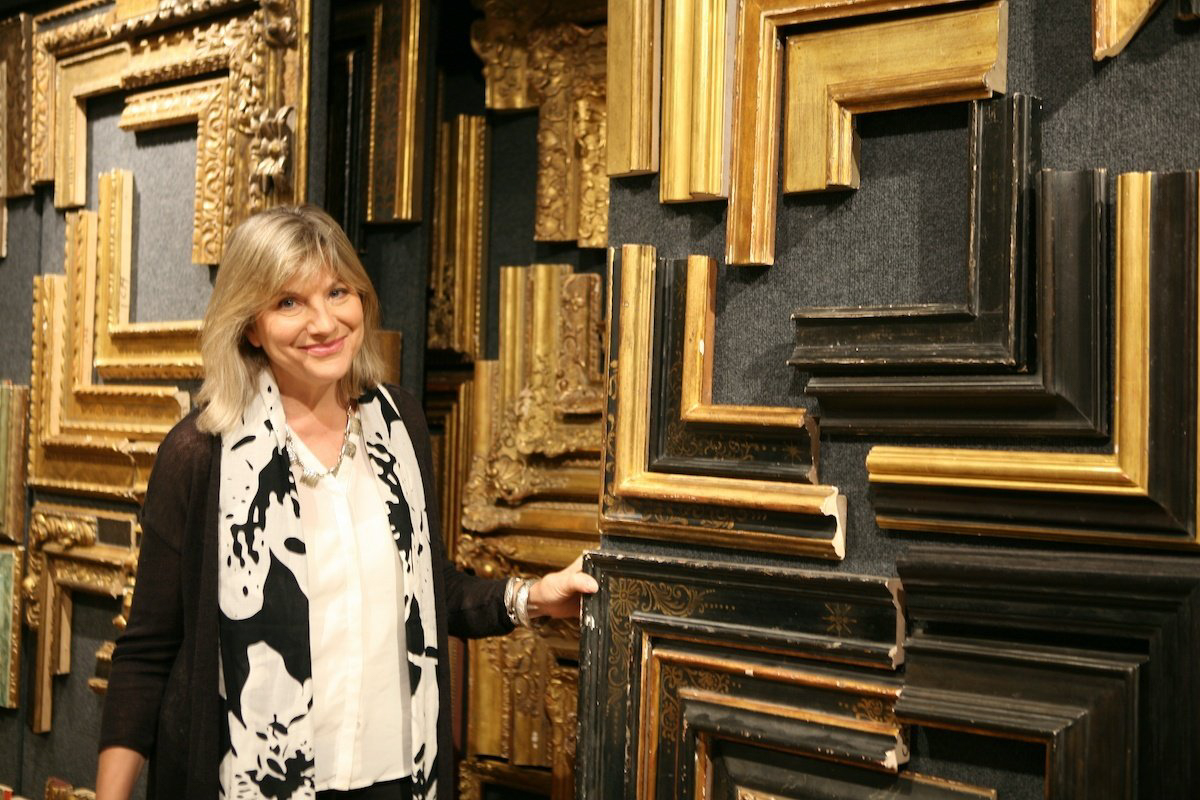 Lisa Wyer poses with a selection of frame corners in the Lowy Showroom