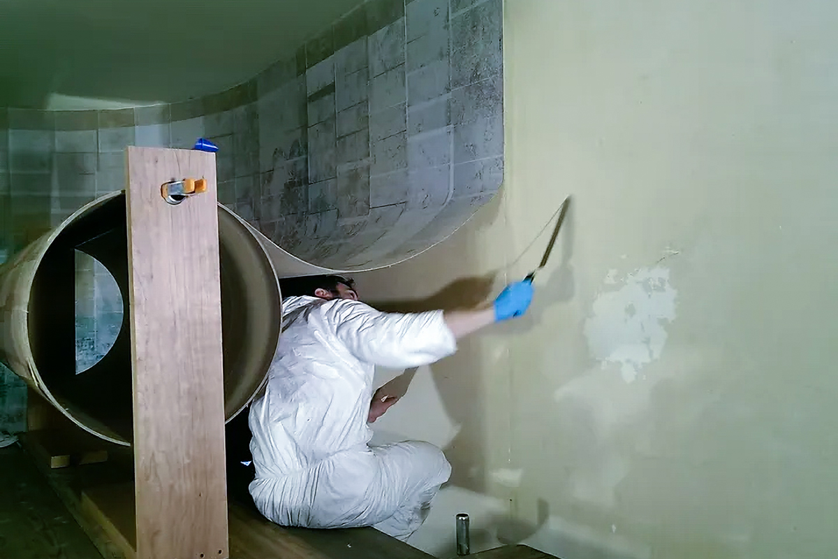 Lowy Conservator Removing Section of Whitney Studio Mural From Wall
