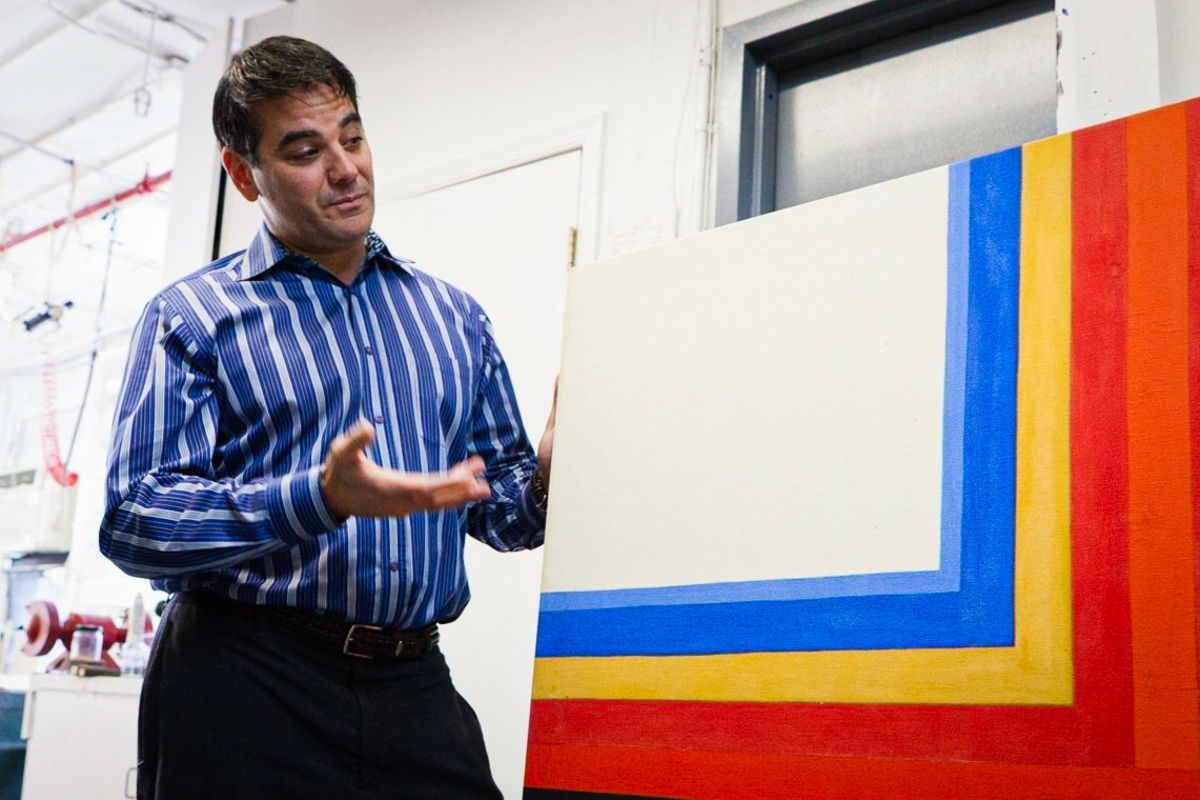 Lowy President Brad Shar Reviewing a Painting After Conservation