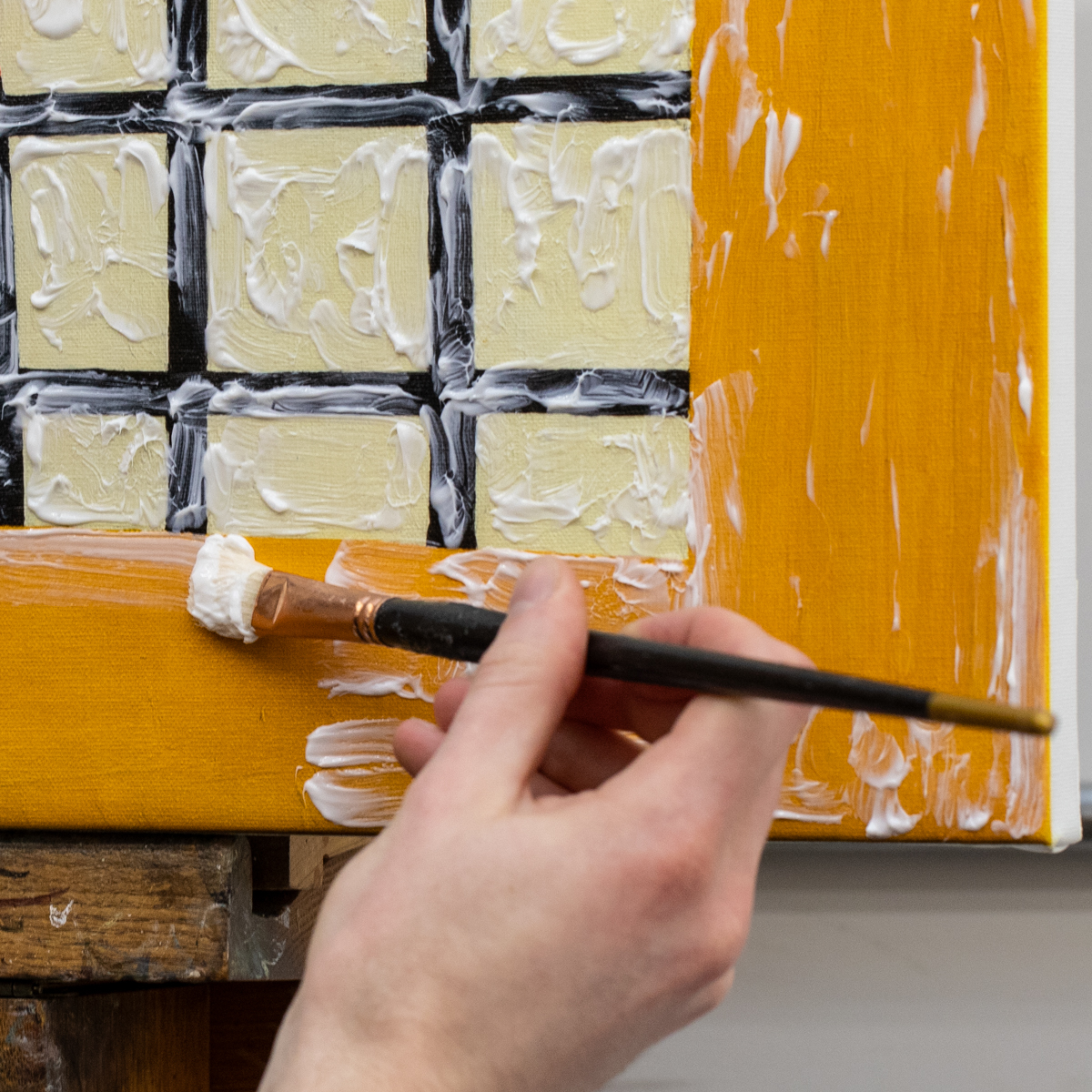 A Lowy art conservator applies clear gel to a canvas print to mimic brush strokes and provide surface texture to the reproduction.